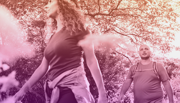 Young white man and woman hiking outdoors.