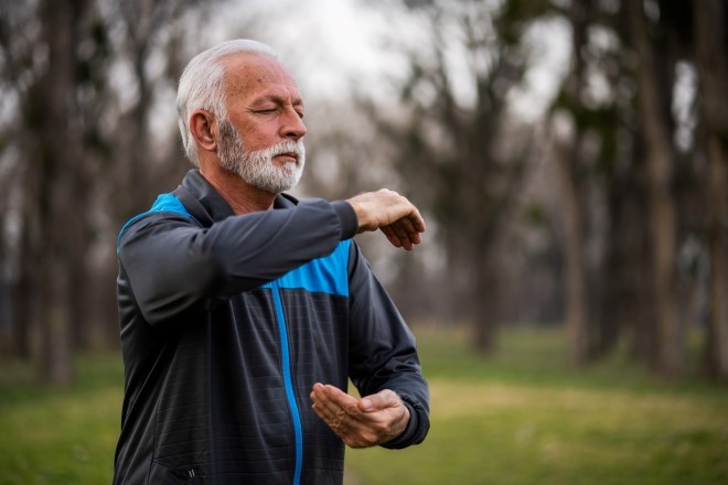 older man doing a yoga pose