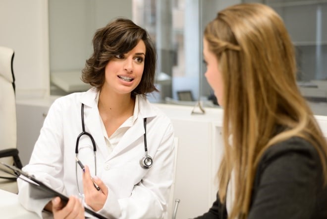 doctor talking to a young woman patient